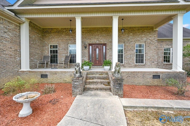 83 James Rd, Hartselle, AL 35640 - doorway to property with a porch, brick siding, and crawl space