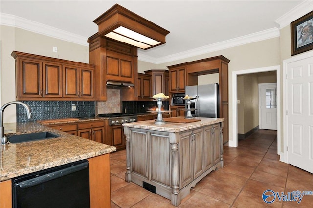 83 James Rd, Hartselle, AL 35640 - kitchen featuring appliances with stainless steel finishes, backsplash, under cabinet range hood, light stone counters, and crown molding