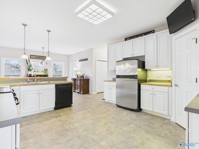 kitchen with a sink, white cabinetry, dishwasher, and freestanding refrigerator