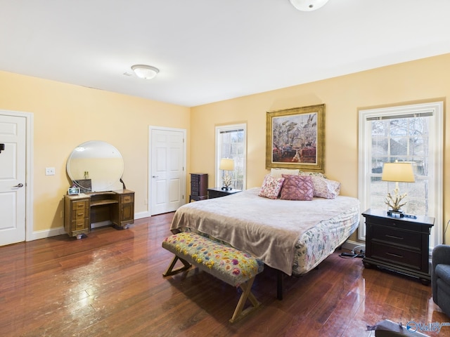 bedroom featuring dark wood finished floors and baseboards