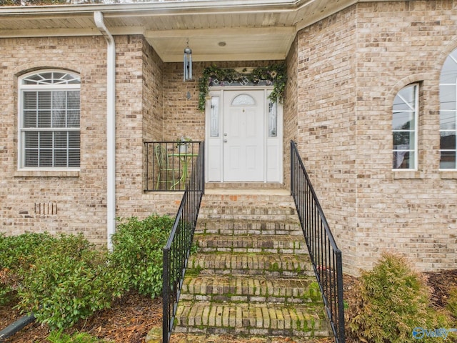 property entrance with crawl space and brick siding