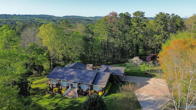 birds eye view of property with a wooded view