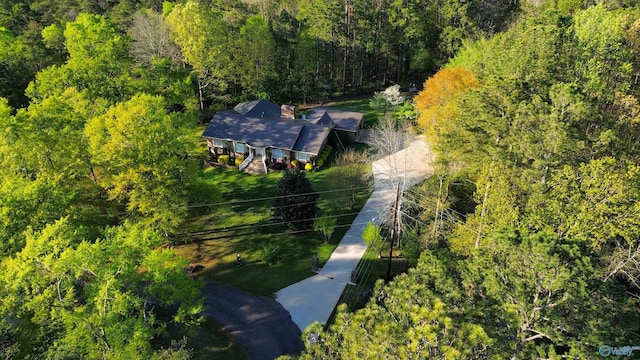 birds eye view of property with a view of trees