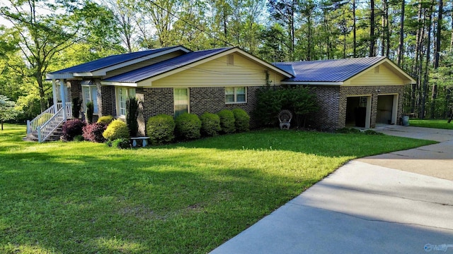 ranch-style house with an attached garage, concrete driveway, brick siding, and a front yard
