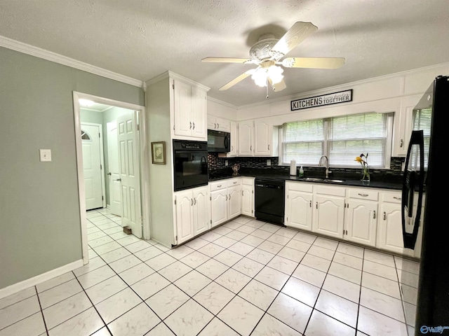 kitchen featuring ornamental molding, dark countertops, black appliances, and a sink