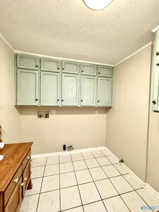 clothes washing area featuring crown molding, a textured ceiling, washer hookup, and cabinet space