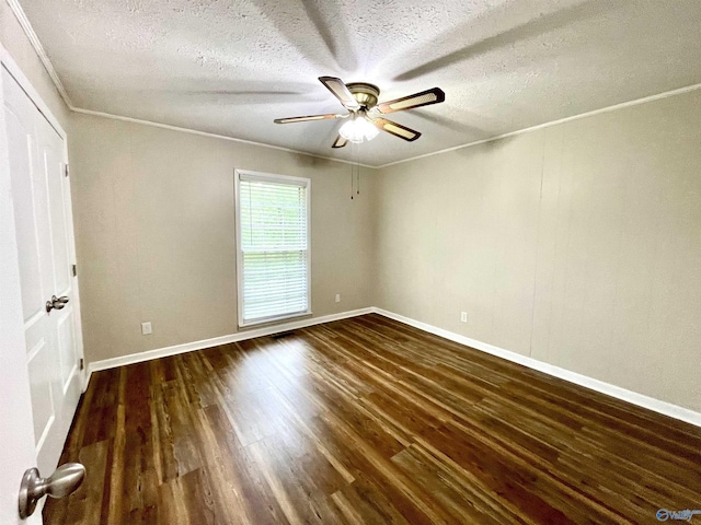 unfurnished bedroom featuring crown molding, a textured ceiling, dark wood-style flooring, and baseboards