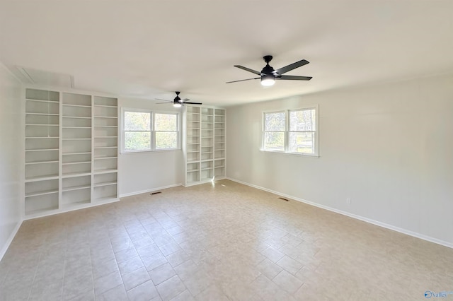 empty room featuring a wealth of natural light and ceiling fan