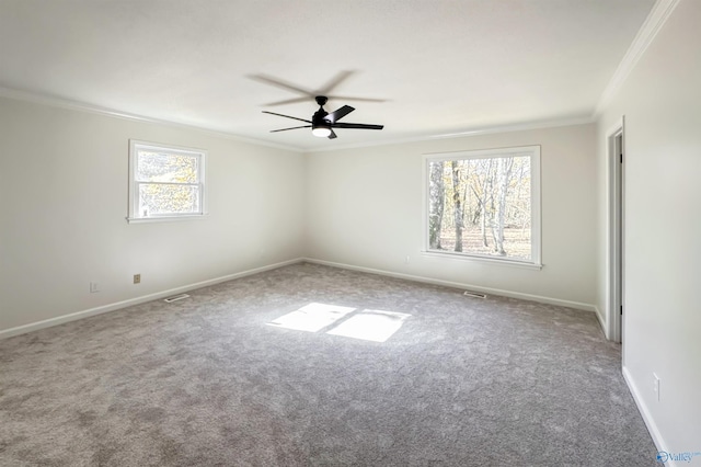 carpeted empty room with ceiling fan and ornamental molding