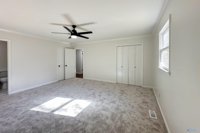 unfurnished bedroom with ceiling fan, crown molding, connected bathroom, and light carpet