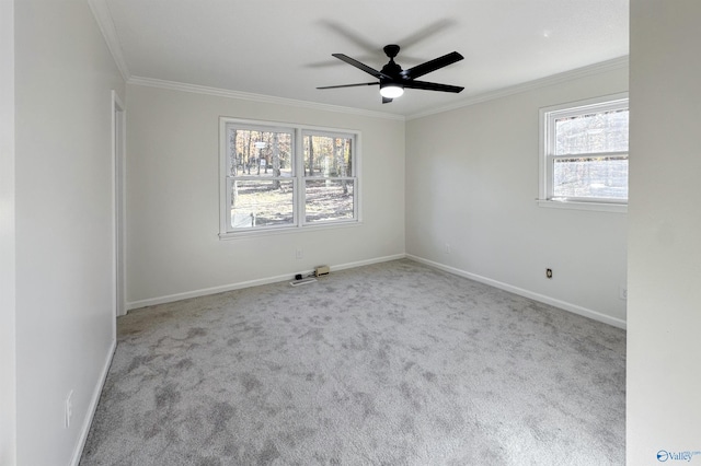 spare room featuring light colored carpet and a wealth of natural light