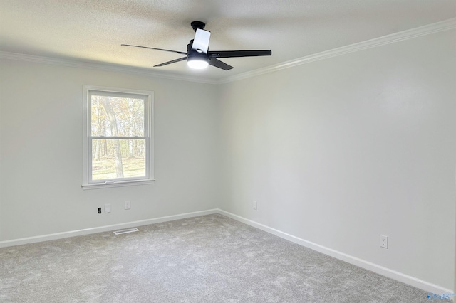 unfurnished room featuring carpet, a textured ceiling, ceiling fan, and ornamental molding