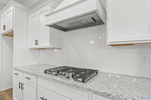 kitchen featuring white cabinets, custom exhaust hood, tasteful backsplash, and dark wood-type flooring