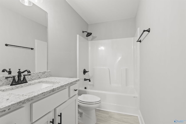 full bathroom featuring toilet, vanity, and washtub / shower combination