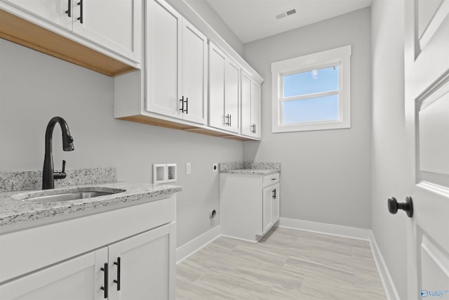 clothes washing area featuring sink, cabinets, hookup for an electric dryer, and hookup for a washing machine