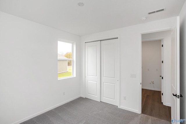 unfurnished bedroom with carpet and a closet