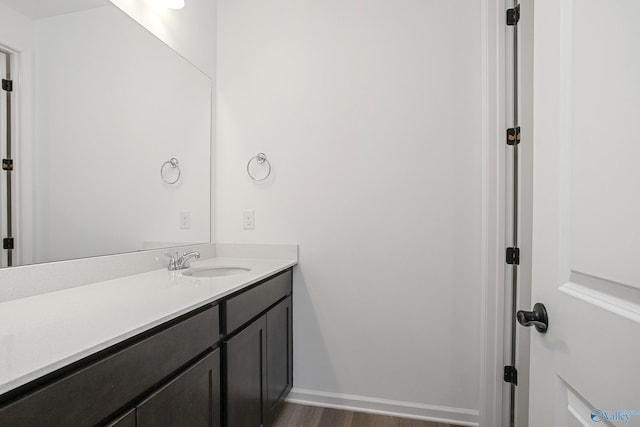 bathroom with vanity and hardwood / wood-style floors