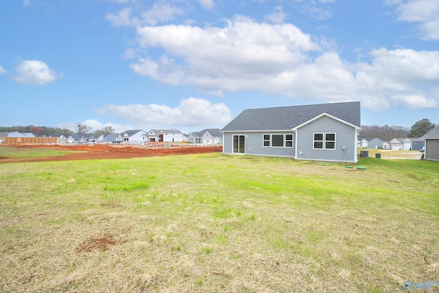 rear view of house with a yard