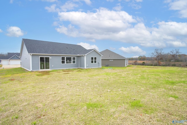 rear view of property with a yard