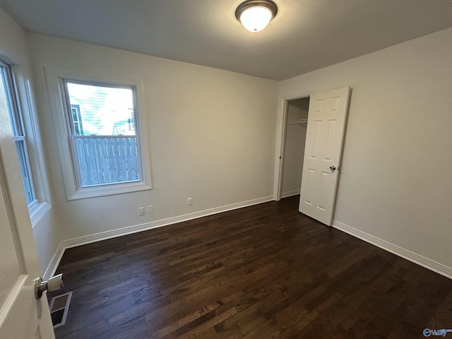 unfurnished bedroom featuring dark hardwood / wood-style flooring