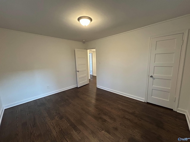 unfurnished room with dark hardwood / wood-style floors and ornamental molding