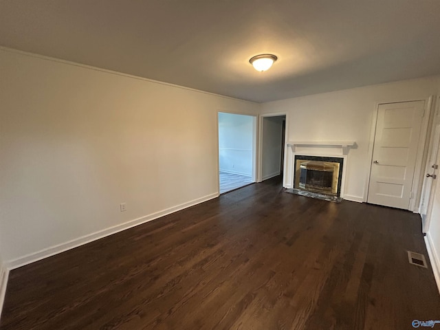 unfurnished living room featuring a premium fireplace and dark hardwood / wood-style flooring