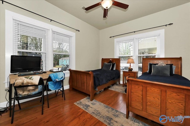 bedroom with ceiling fan and dark hardwood / wood-style flooring