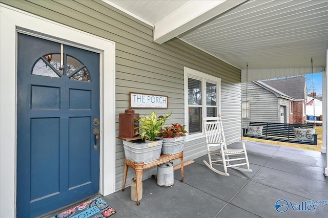 view of exterior entry with a porch