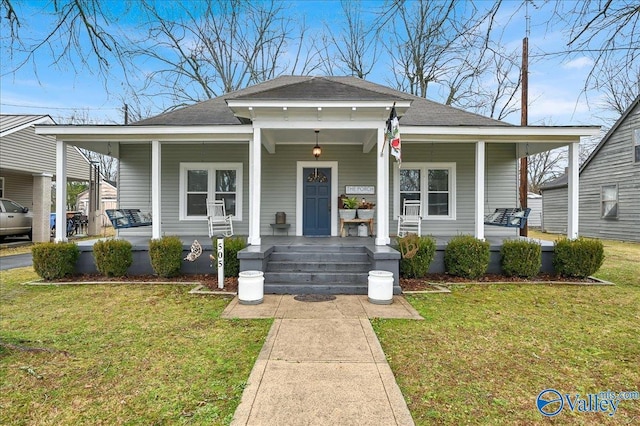 bungalow with a front lawn and a porch