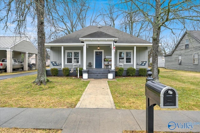 bungalow-style home with covered porch and a front yard