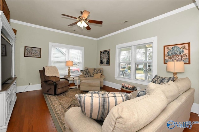 living room with ceiling fan, a healthy amount of sunlight, dark hardwood / wood-style floors, and crown molding