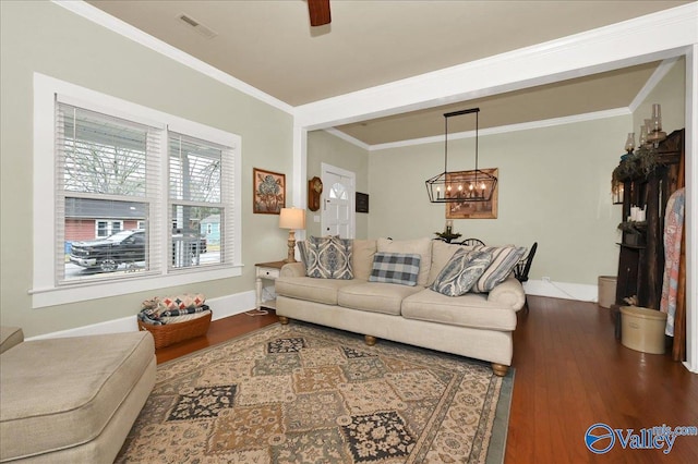 living room featuring ceiling fan with notable chandelier, hardwood / wood-style floors, and ornamental molding
