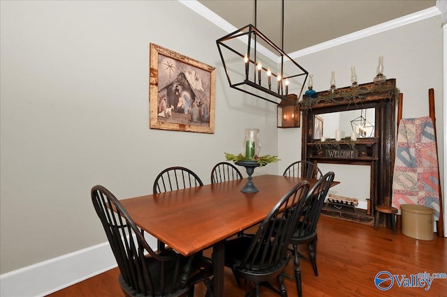 dining space with crown molding, a chandelier, and hardwood / wood-style flooring