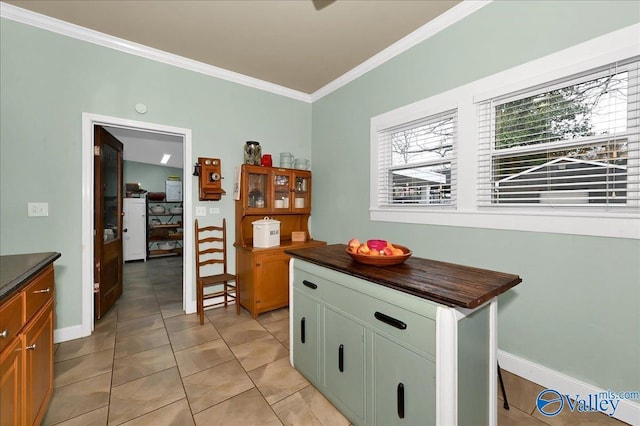 kitchen with crown molding and light tile patterned flooring