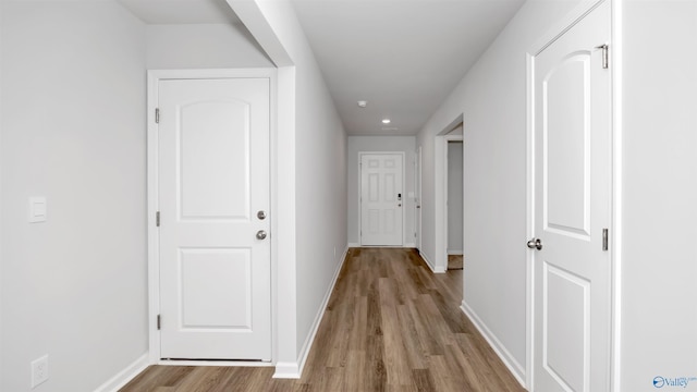 corridor with light hardwood / wood-style floors