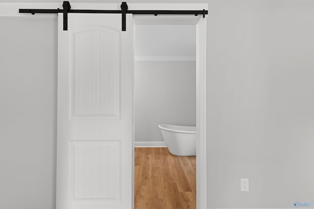 bathroom featuring wood finished floors and baseboards