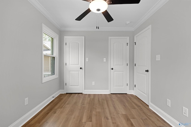 unfurnished bedroom featuring light wood-style floors, ornamental molding, baseboards, and ceiling fan