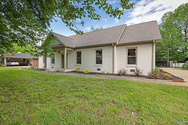 ranch-style house featuring brick siding, roof with shingles, and a front yard