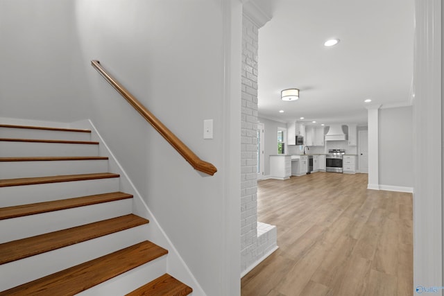 staircase featuring recessed lighting, wood finished floors, and baseboards