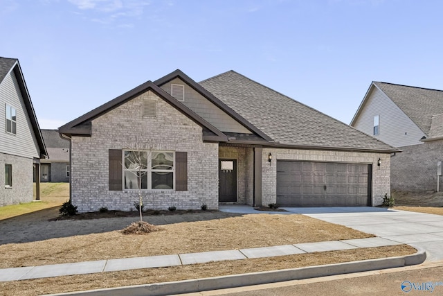177 Pennington Ave, Huntsville, AL 35811 - view of front facade with a garage, brick siding, concrete driveway, and a shingled roof
