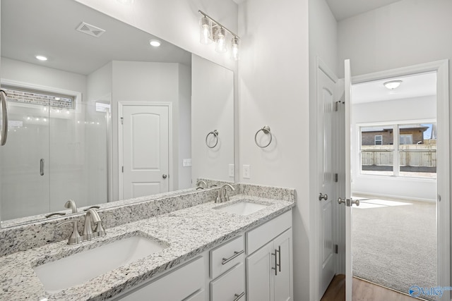 177 Pennington Ave, Huntsville, AL 35811 - bathroom with double vanity, a stall shower, wood finished floors, and recessed lighting
