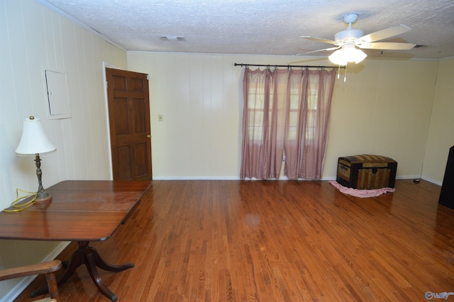 home office with wood-type flooring, a textured ceiling, crown molding, and ceiling fan