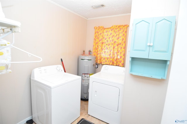 clothes washing area with cabinets, water heater, crown molding, and washing machine and dryer