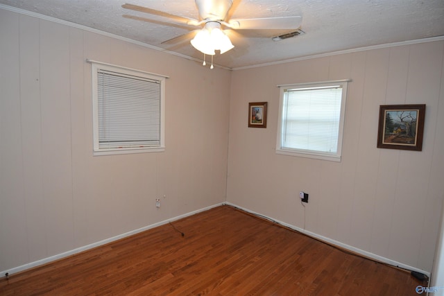 empty room with ornamental molding, ceiling fan, and hardwood / wood-style floors