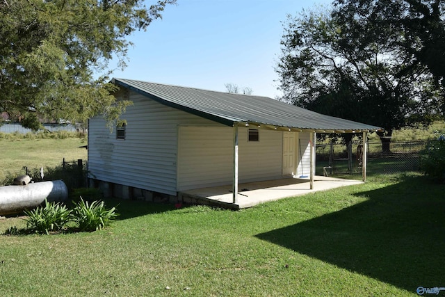 view of outbuilding featuring a yard