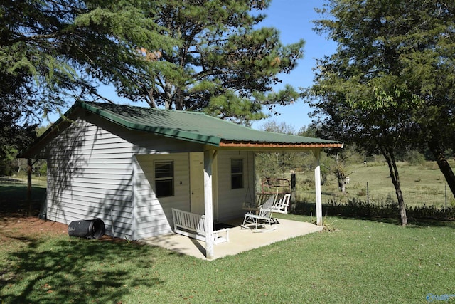 back of property with a patio and a lawn