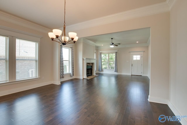 unfurnished living room with dark wood-type flooring, ceiling fan with notable chandelier, and ornamental molding