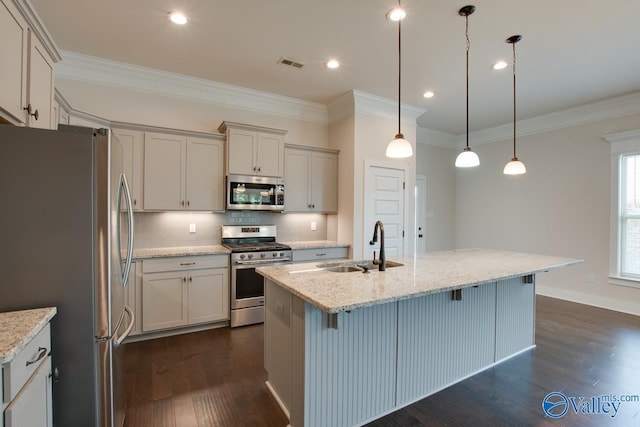 kitchen featuring light stone counters, stainless steel appliances, a kitchen bar, dark hardwood / wood-style flooring, and a kitchen island with sink