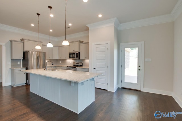 kitchen featuring dark wood-type flooring, light stone countertops, appliances with stainless steel finishes, and sink