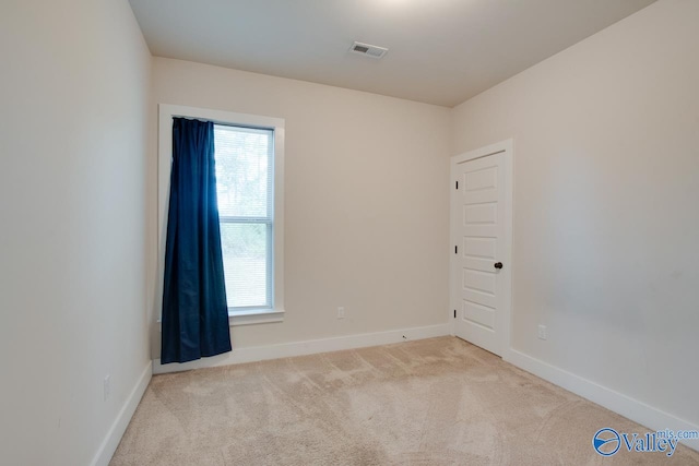 spare room with light colored carpet